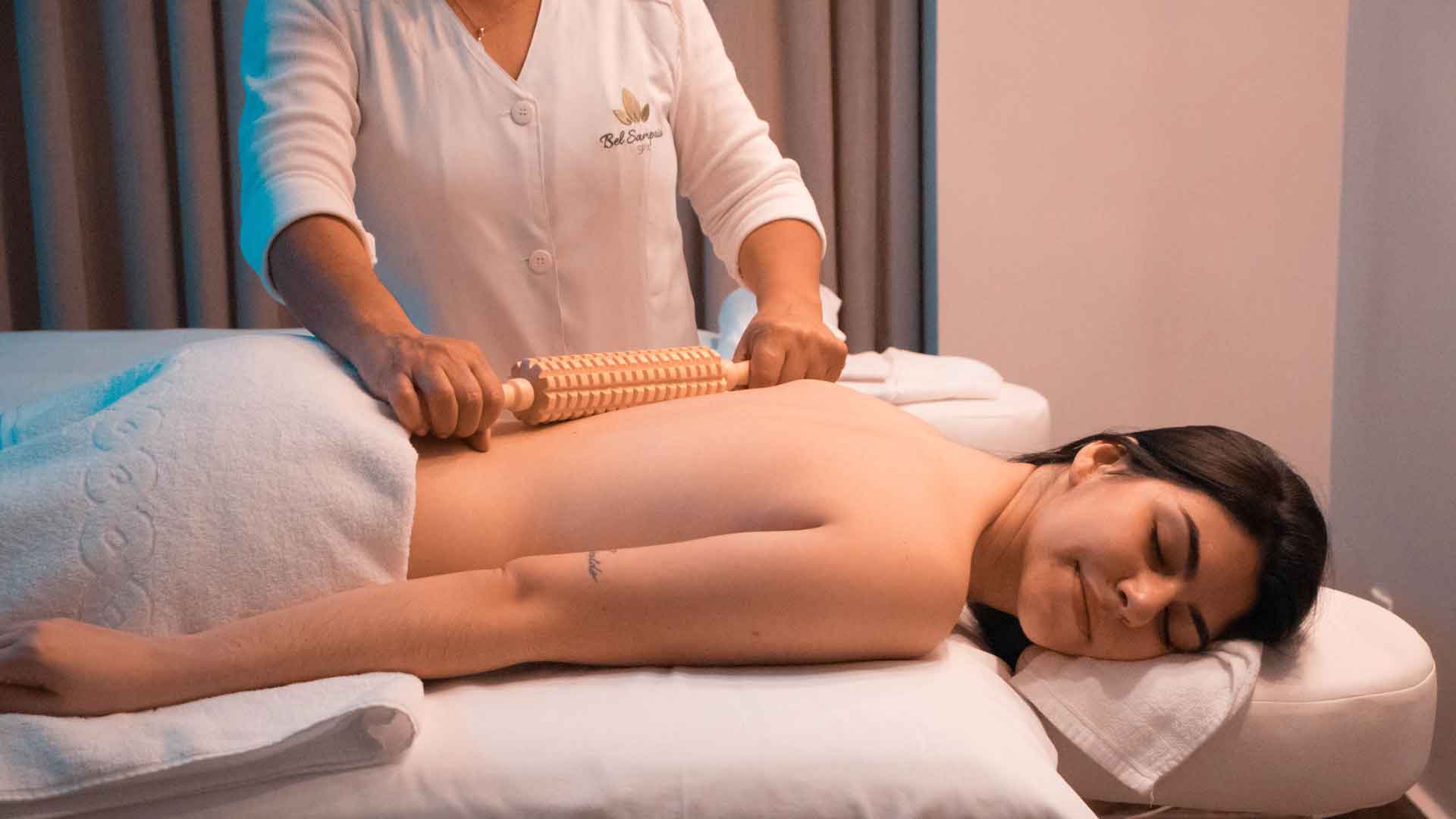 A person enjoying a #1 relaxing back massage in a comfortable home setting in Delhi NCR.